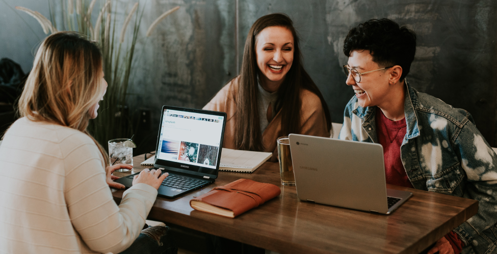 people on laptops and smiling
