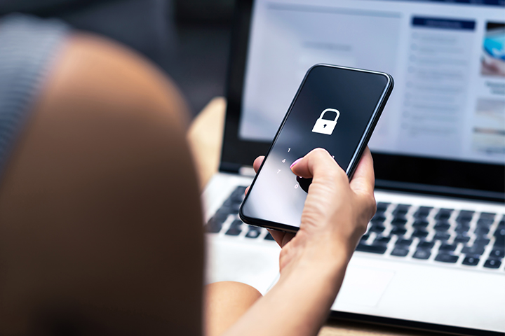 Woman typing WiFi password into phone