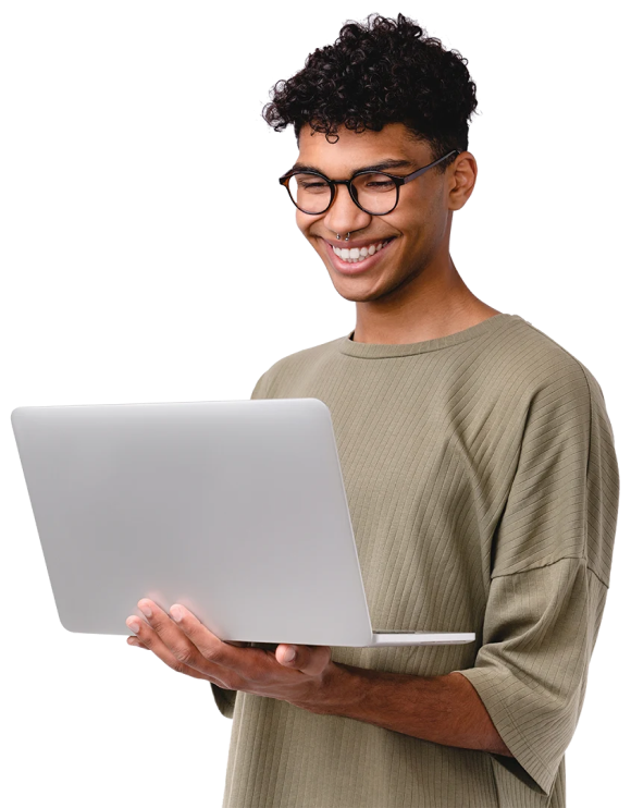 teenage boy standing with a laptop in hands