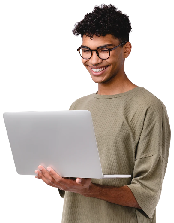 teenage boy standing with a laptop in hands